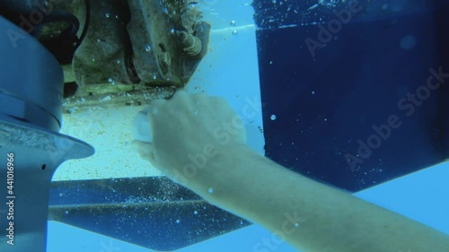 Slow motion - First person POV - Male arm scrubbing the boat's hull