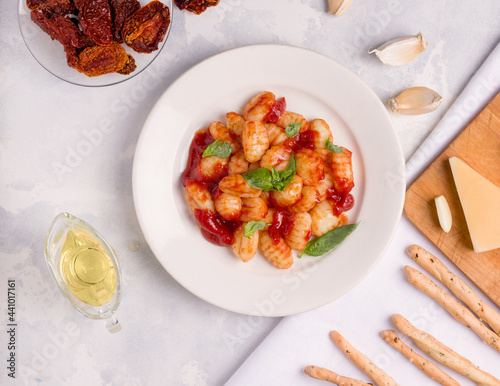 Gnocchi with tomato sauce on a light background. View from above. Italian food photo