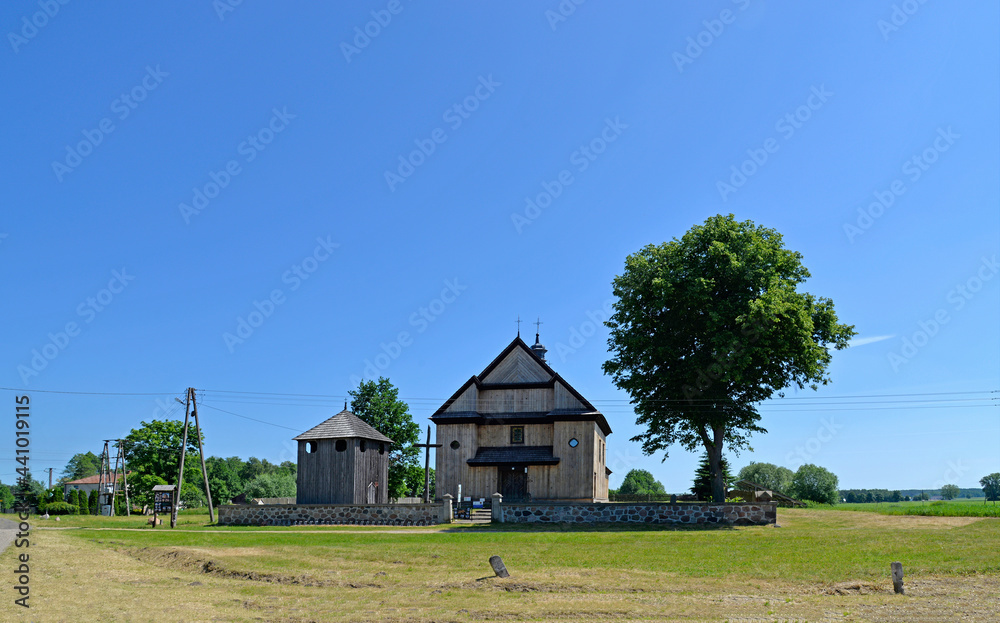Obraz premium The belfry built in 1792 with the church of St. John the Baptist in the village of Gąsiorowo in Masovia, Poland. The photos show a general view and architectural details of the temple and belfry.