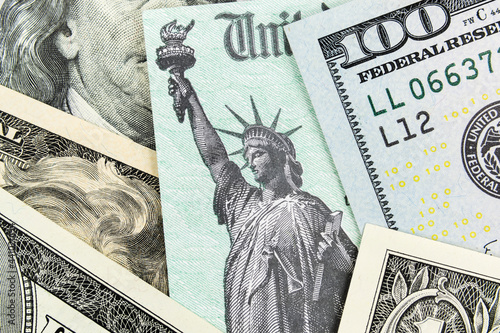 Macro view of the Statue of Liberty on a United States Treasury Check with currency in background.  photo
