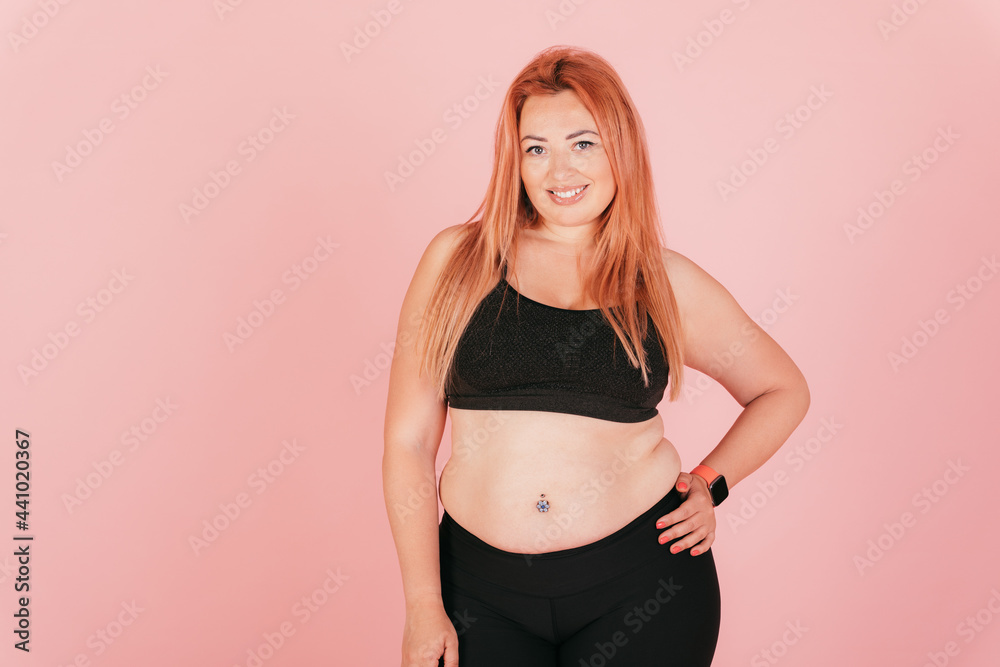 Beautiful happy plus size young woman wearing sporty outfit Beautiful happy plus size young woman wearing sporty outfit