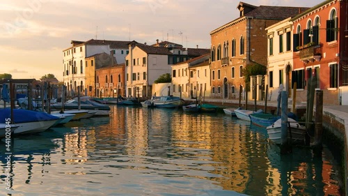 Sunset Canale San Donato - Sunset view of the calm and colorful Canale San Donato on Murano Islands. Venice, Veneto, Italy. photo