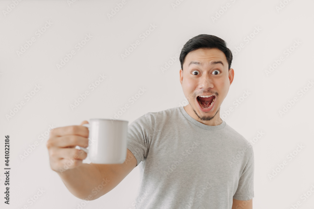 Surprised face of Asian man drinks a cup of coffee isolated on white background. Surprised face of Asian man drinks a cup of coffee isolated on white background.