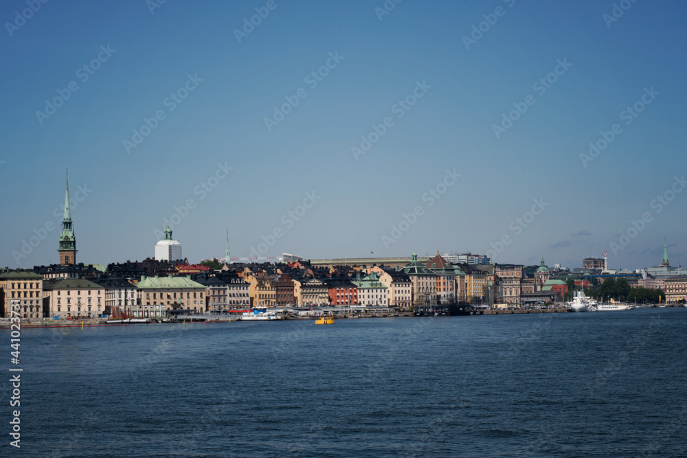 View of the Old Town skyline in Stockholm with the water surrounding it. Photo taken on a beautiful summer day in Sweden.
