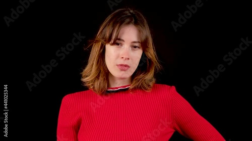 Young beautiful woman standing over black isolated background doing loser gesture, nooding.