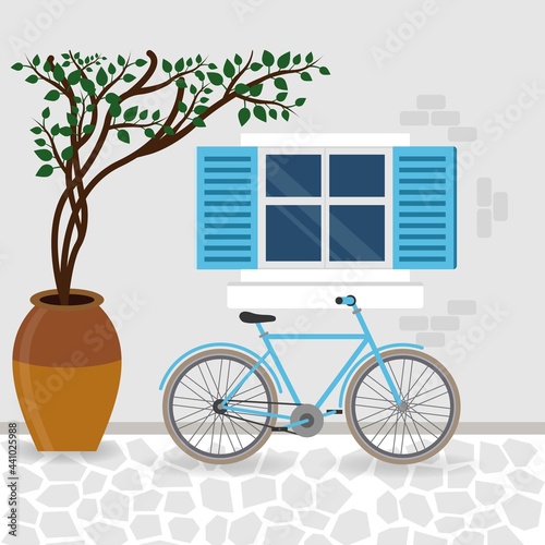 Bicycle near a wall with window and plant in a pot