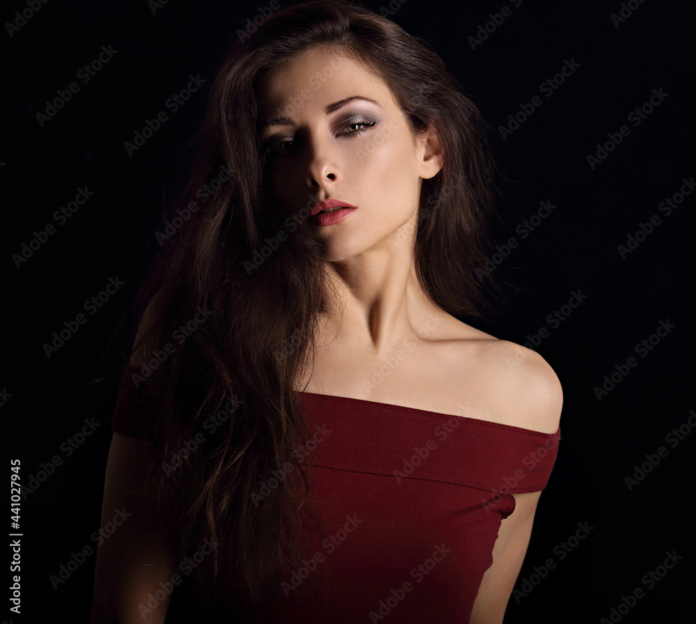Beautiful mysterious woman makeup face with wisdom emotional look on dramatic shadow black background with empty copy space. Closeup Beautiful mysterious woman makeup face with wisdom emotional look on dramatic shadow black background with empty copy space. Closeup