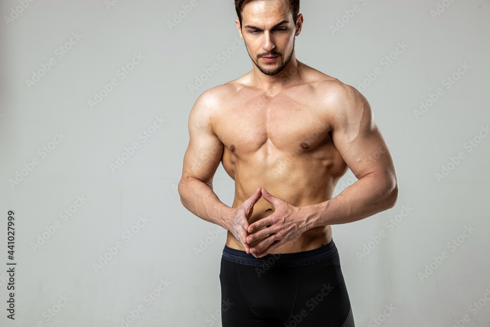 portrait of a handsome man posing with a naked torso on a white background portrait of a handsome man posing with a naked torso on a white background