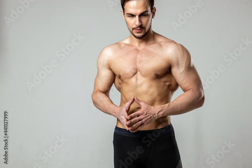 portrait of a handsome man posing with a naked torso on a white background
