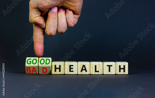 Good or bad health symbol. Doctor turns wooden cubes and changes words bad health to good health. Beautiful grey background, copy space. Medical and good or bad health concept.