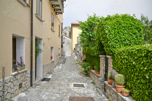 Fototapeta Naklejka Na Ścianę i Meble -  A small street between the old houses of Pietrabbondante, a medieval village in the mountains of the Molise region in Italy.