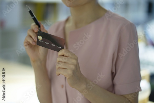 Woman holding credit card in store