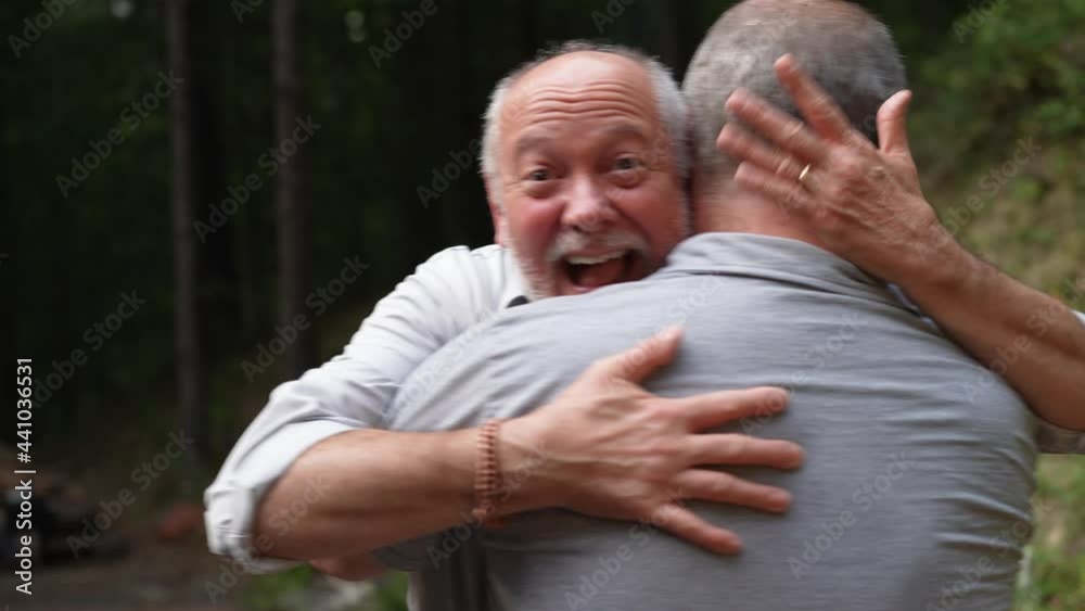 Two men happy men hugging with smiles looking at ring for their engagement. Two men happy men hugging with smiles looking at ring for their engagement.