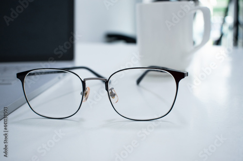 Glasses on the desk in an office.