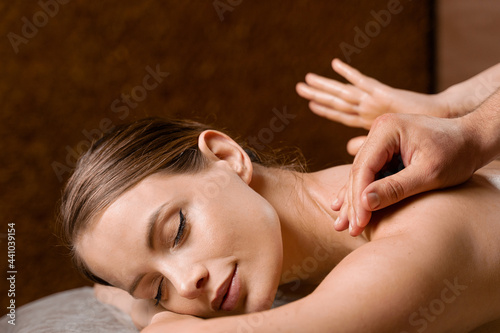 4 hands massage in spa. Two masseurs are making four hands relaxing massage with oil for girl. Relaxation. Manual therapy