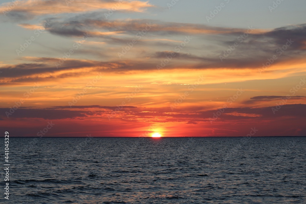 bright beautiful red-yellow sunset on the sky against the background of the sea