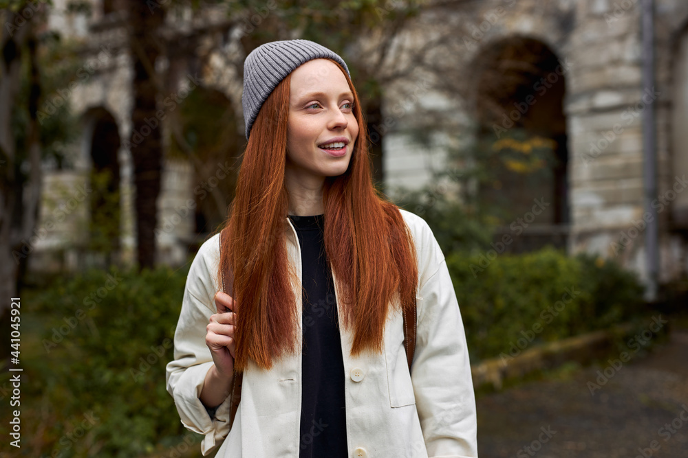 Ταπετσαρία Close-up Portrait Of Dreamy Woman With Natural Red Hair On Travel Trip, Outdoors, Posing At Camera, Smiling, in Coat And Hat