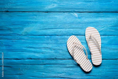 Flip flops shoes on the blue wooden floor background.