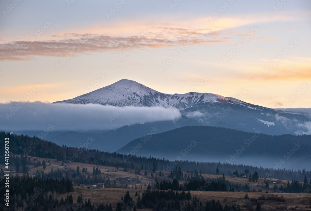 Picturesque morning above late autumn mountain countryside.  Ukraine, Carpathian Mountains, Petros top in far. Peaceful traveling, seasonal, nature and countryside beauty concept scene.