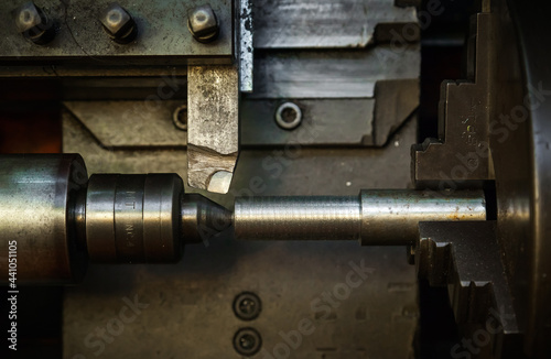 Mechanical processing of metal on a lathe, close-up. The steel bar is clamped in the lathe and the cutter is brought in. 
