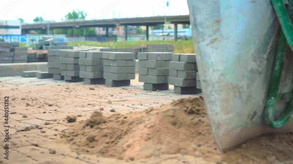 The final stage of laying paving slabs is filling the gaps with dry