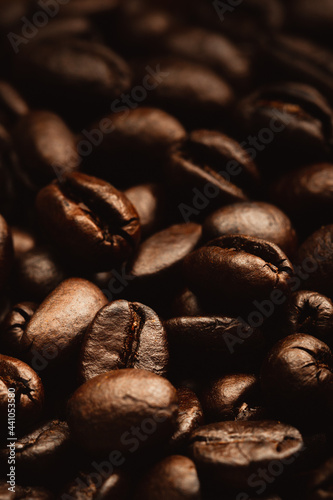 close up dark roasted coffee beans on heap, Low light picture style and showing detail with texture