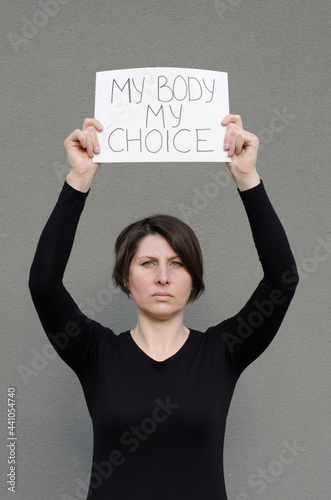 Woman showing protest banner with the message my body my choice. Right to abortion. Human rights freedom. Stop discrimination.