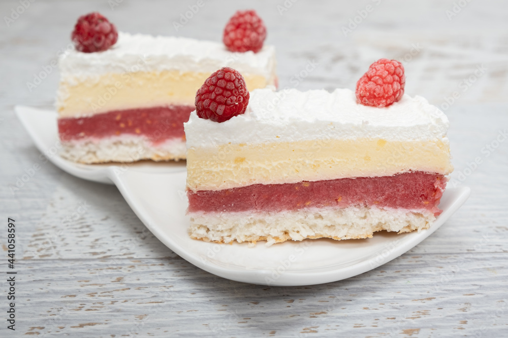 Piece of vanilla slice cake, and raspberries