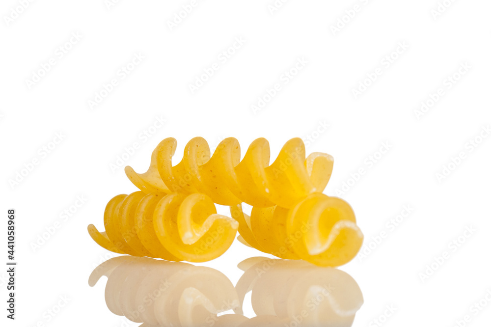 Spiral shaped pasta made of durum wheat, close-up, isolated on a white background Spiral shaped pasta made of durum wheat, close-up, isolated on a white background