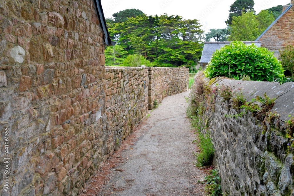 Little street with walls in stones on the Brehat island in Brittany France