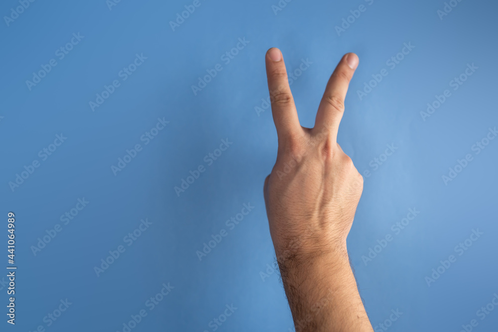 hand on blue screen making number 2 hand on blue screen making number 2