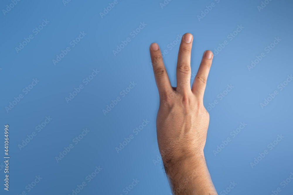 hand on blue screen making number 3 hand on blue screen making number 3