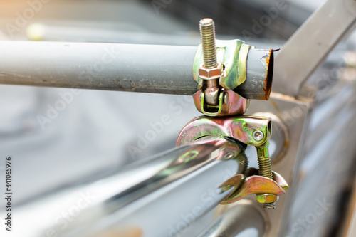 Obraz na płótnie Selective focus to scaffolding pipe clamp and parts, An important part of building strength to scaffold clamps in used close up on construction site