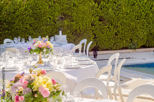 Cute shot of set table with empty dishes, clean glasses, and bouques for a wedding reception photo