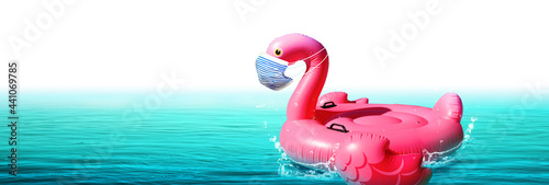 Inflatable swan with corona virus mask on vacation © Thaut Images