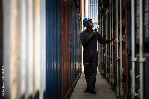 Portrait of worker using radios at the port