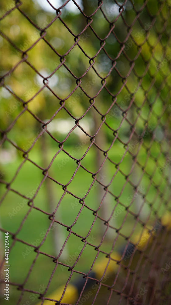 Rusted wire fence, focus selected. Most area blur Rusted wire fence, focus selected. Most area blur