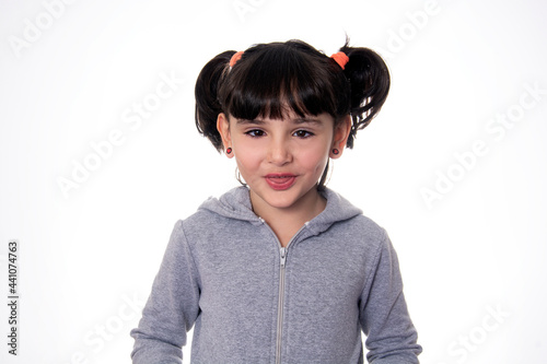 child wearing gray on white background grimacing