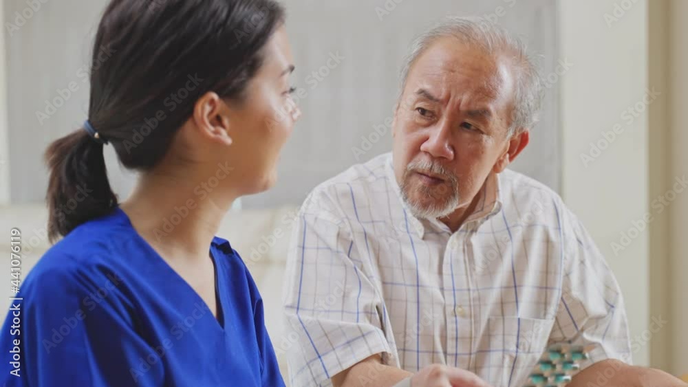 Asian female nurse explaining medicine instruction to old man patient. Asian female nurse explaining medicine instruction to old man patient.