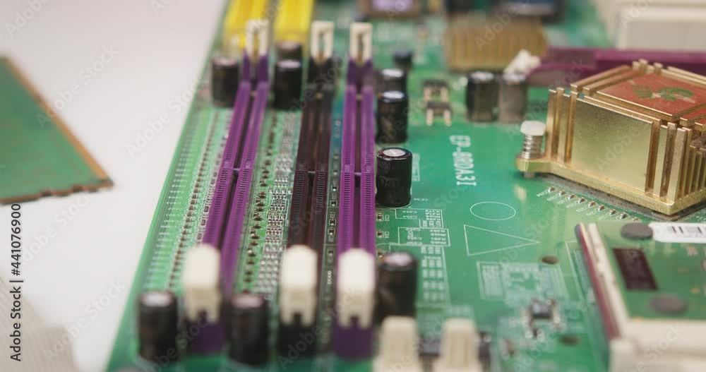Close-up of cleaning details for gadget with brush, fixing and repairing in protective blue gloves. Electronics, assembly of computer components at workplace in repair service center. Close-up of cleaning details for gadget with brush, fixing and repairing in protective blue gloves. Electronics, assembly of computer components at workplace in repair service center.