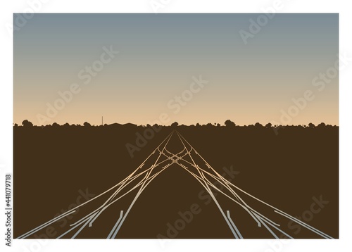 Rail yard in the morning with building and trees silhouette background