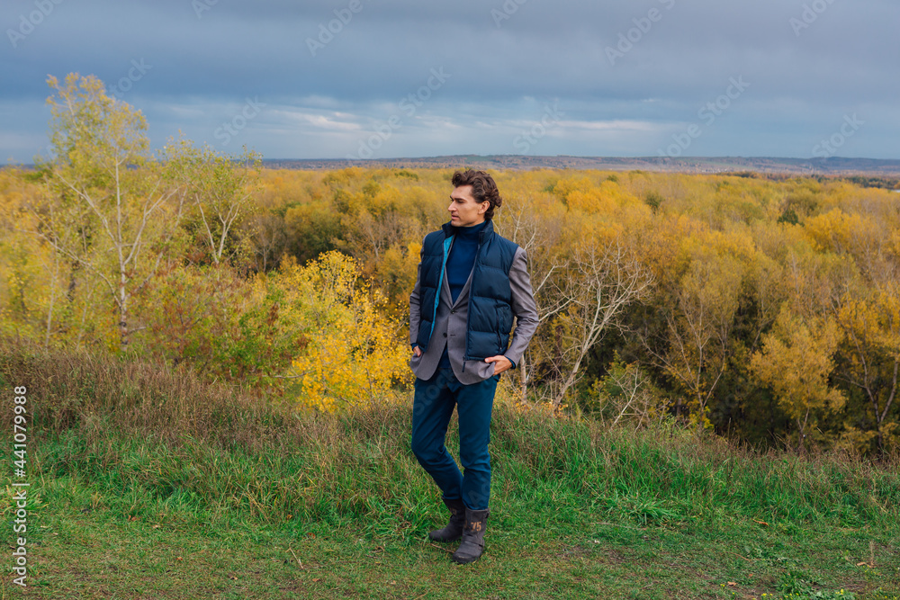 Tall handsome man outdoor in autumn forest on the hill Tall handsome man outdoor in autumn forest on the hill