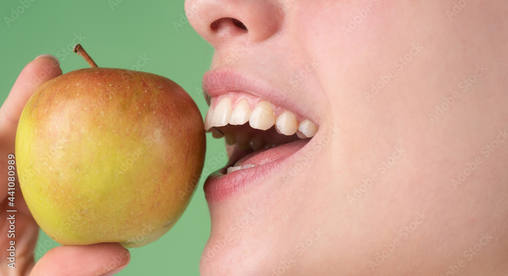 Beautiful young woman eating a apple. Healthy white teeth close up with an apple. Beautiful young woman eating a apple. Healthy white teeth close up with an apple.