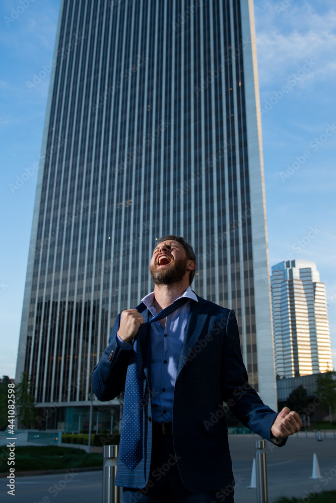 Angry businessman in suit after work in office. Screaming face. Angry businessman in suit after work in office. Screaming face.