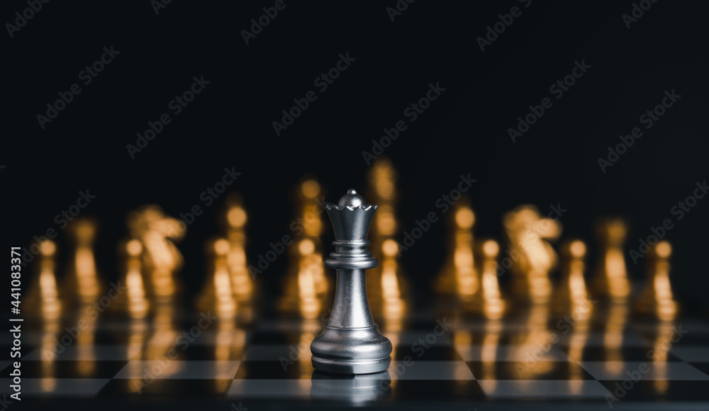 Silver king winner surrounded with silver chess pieces on chess board game competition.concept strategy, leadership and success business. Silver king winner surrounded with silver chess pieces on chess board game competition.concept strategy, leadership and success business.