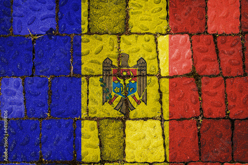 National flag of Moldova on stone wall background. Flag banner on stone texture background.