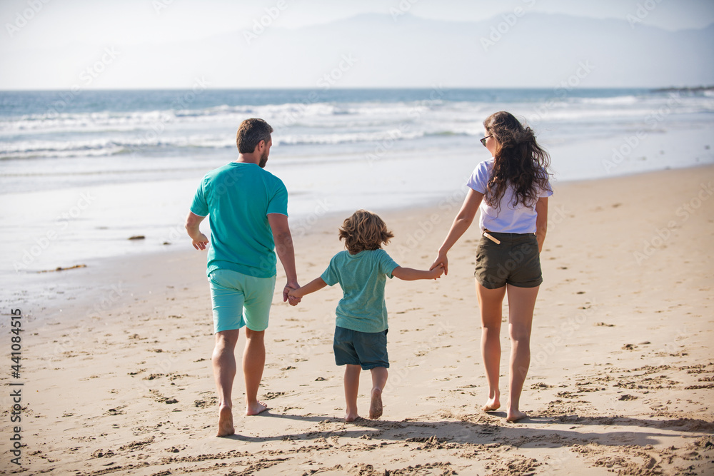 Father mother and child on the summer beach at the sunset time. Concept of friendly family. Summer holidays in Fiji. Father mother and child on the summer beach at the sunset time. Concept of friendly family. Summer holidays in Fiji.