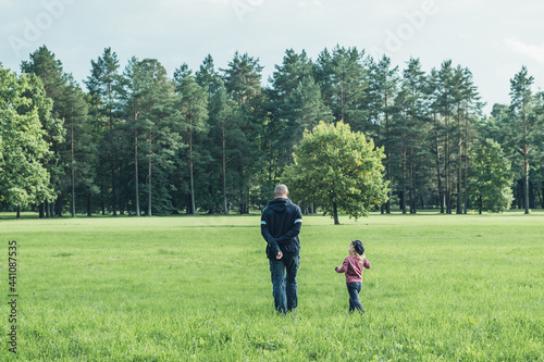 Father and daughter spending time on the field. Concept of friendly family. Great family vacation.