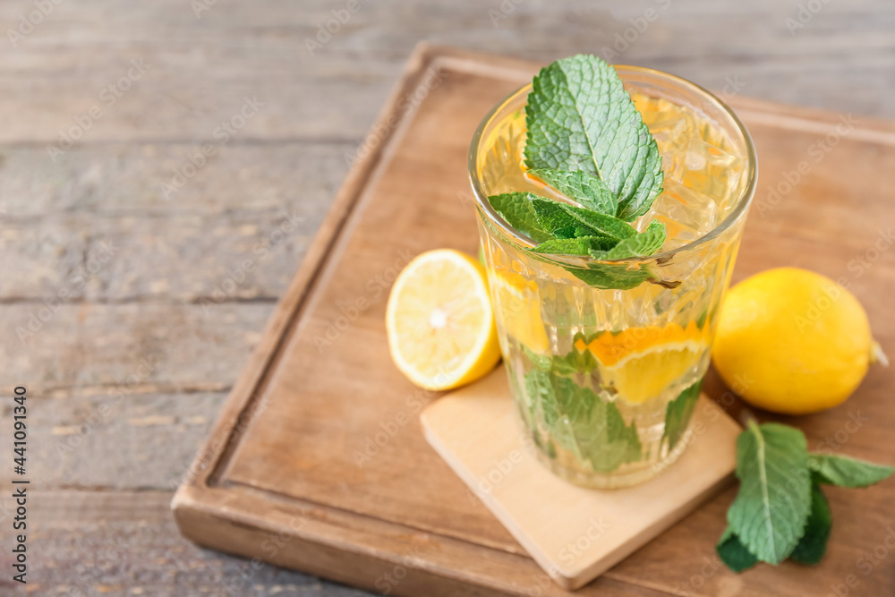 Fototapeta premium Glass of tasty ice tea with lemon on wooden background