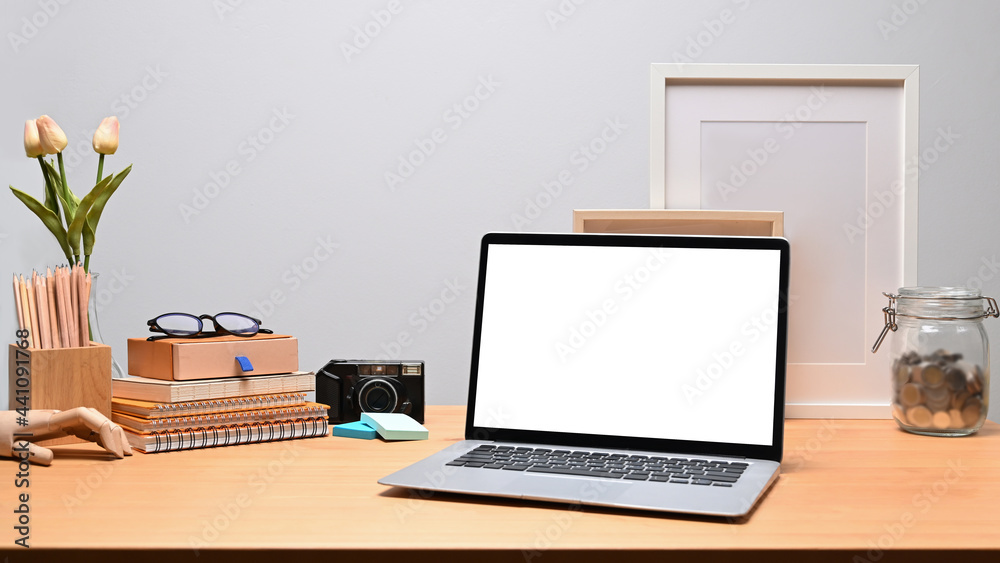 Mock up computer laptop, books and pencil holder on wooden desk. Mock up computer laptop, books and pencil holder on wooden desk.